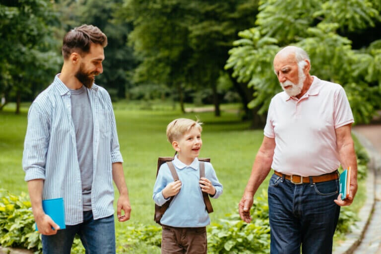 Grandfather helping his grandchild with school — a joyful example of ways grandparents can join the back-to-school season.