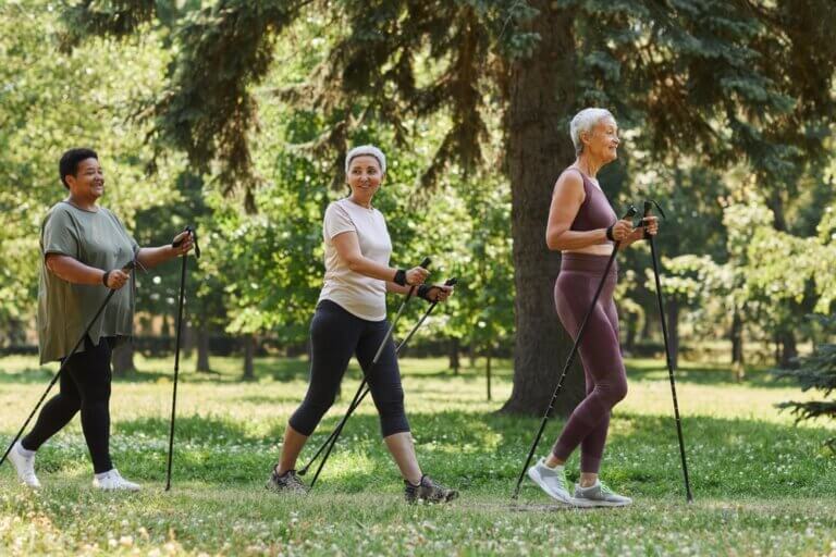 Elderly women walking in shaded park