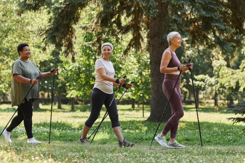 Elderly women walking in shaded park