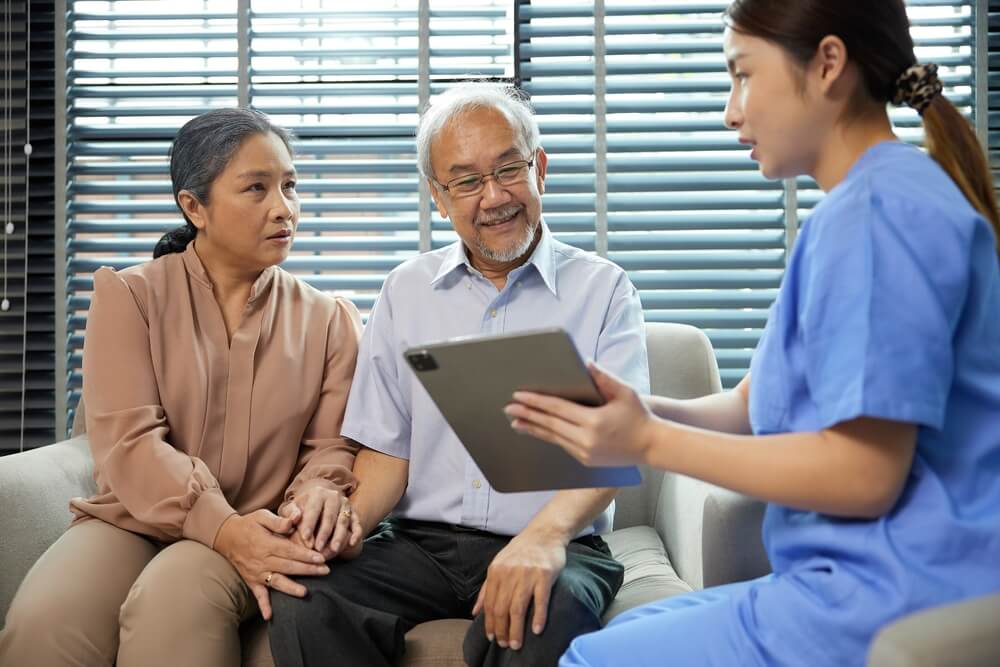 Home caregiver assisting with a mid-year senior care review checklist